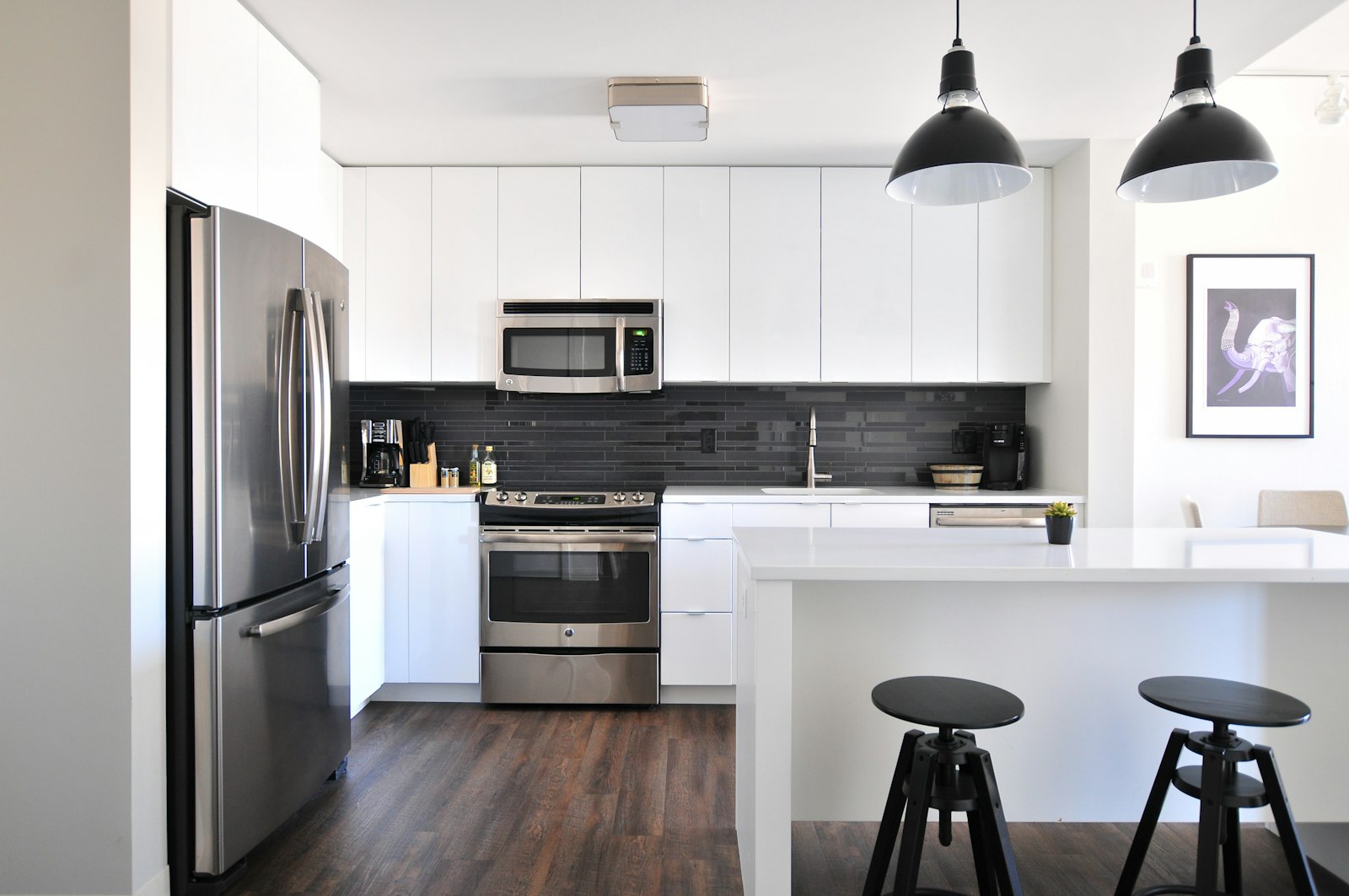 Gray steel refrigerator near a modular kitchen